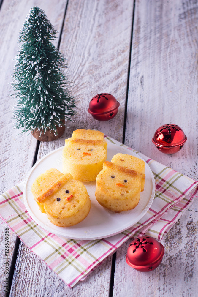 Biscuits in the form of a snowman, tree and red christmas balls. Creative sweets to children's holiday xmas table.