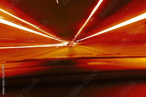 Long exposure speed car lights trails on a night highway.