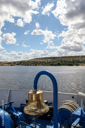 The ship's bell and the river landscape