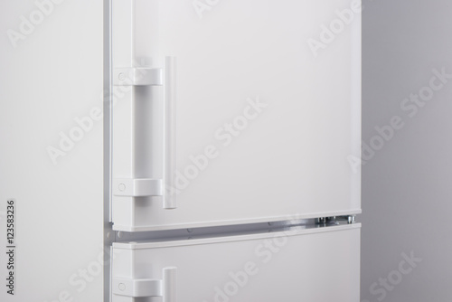 Close up of white refrigerator on gray