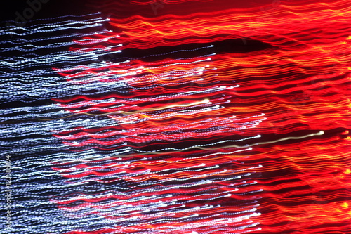 Chaotic lights in moriol blur out of focus - abstract photograph background.