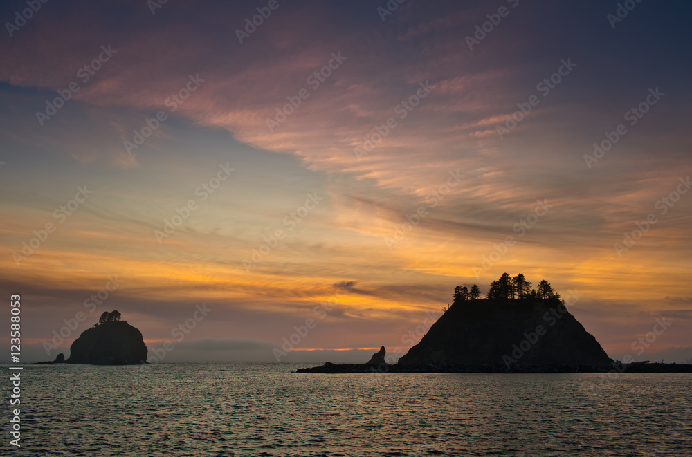 sunset over small islands  in silhouette off the Washington coast on the La Push, Native American Reservation, USA