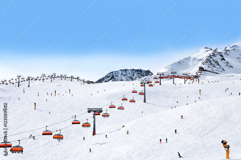 Skiers and chairlifts in Alpine ski resort in Solden in Otztal Alps, Tirol, Austria