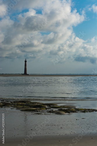 Morris Island lighthouse viewed from beach park in Folly Beach, South Carolina.  © eric