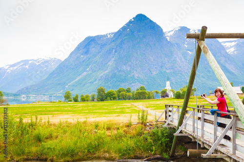 Tourist relaxing on bridge in village Oppstryn Norway photo