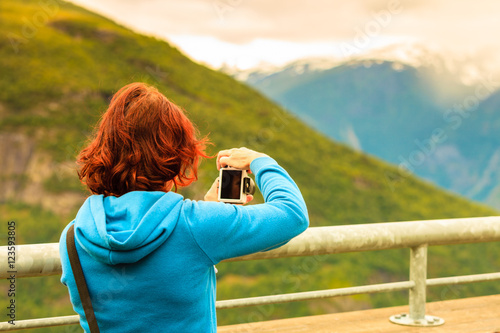 Tourist taking photo from Stegastein viewpoint Norway