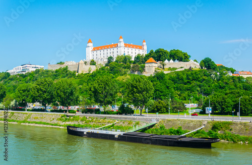 Photography view of the bratislava castle situated on a hill next to the danube river in slo