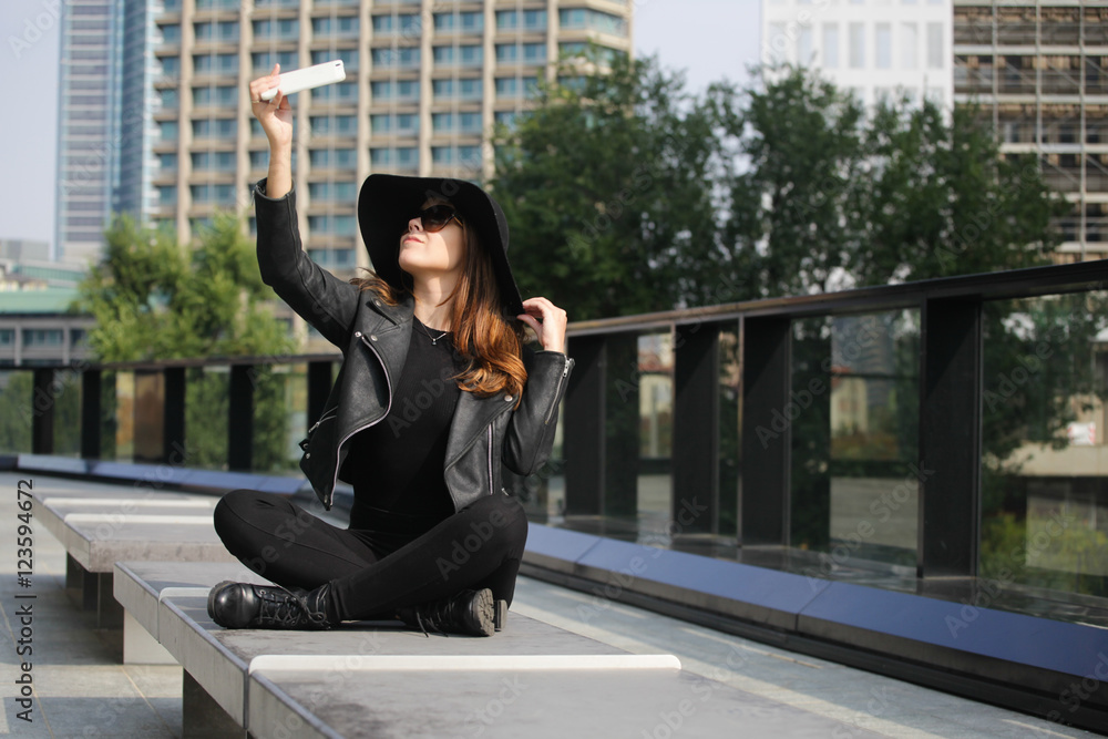 Young beautiful woman taking a selfie in the city Young beautiful woman taking a selfie in the city