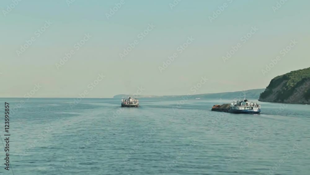Timelapse - view from the bow of moving cruise ship on the river. Two barges, river and riverside. Timelapse - view from the bow of moving cruise ship on the river. Two barges, river and riverside.