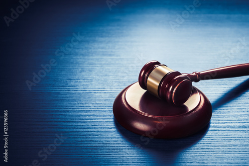 Fotografering judge gavel on a blue wooden background