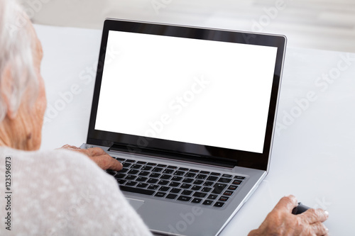 Close-up Of Senior Woman Using Laptop © Andrey Popov