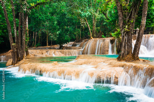 Jangle landscape with amazing turquoise water of Kuang Si cascade waterfall at deep tropical rain forest. Luang Prabang  Laos travel landscape and destinations