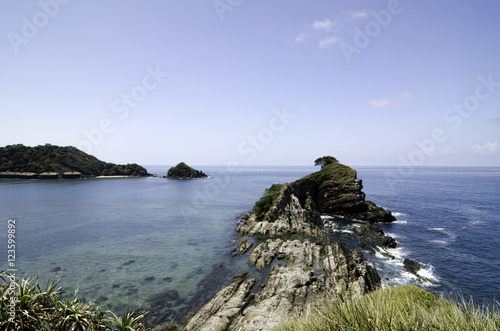 view from the top hill view,an island surrounded by clear water and blue sky background at sunny day.Image taken at Kapas Island, Malaysia. photo