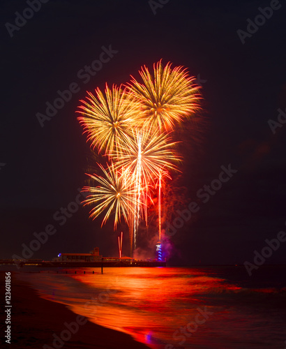 Fireworks in the sky reflected in seas at Bournemouth Pier