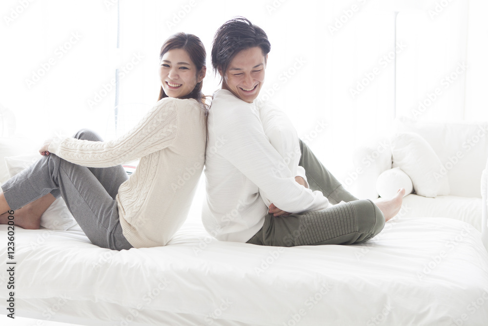 Couple sitting back to back in bed Couple sitting back to back in bed