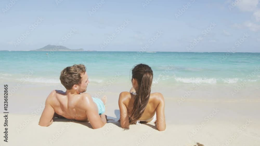 Beach relaxing on holiday vacations in holidays suntan concept - adults lying down tanning on luxury exclusive beach. Beach relaxing on holiday vacations in holidays suntan concept - adults lying down tanning on luxury exclusive beach.