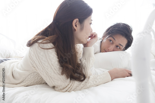 The couple are talking happily in on the bed