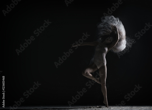 Fototapeta Naklejka Na Ścianę i Meble -  Strange dance with dust performed by graceful girl