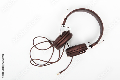 Black headphones against a light coloured background