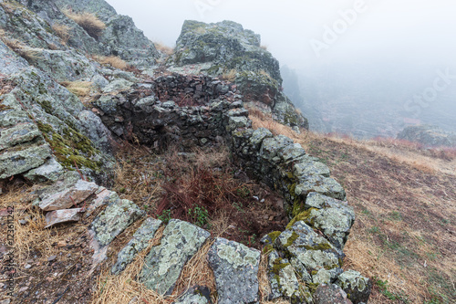 Landscape with fog in Penha Garcia. Portugal.
Ancient ruins in the foreground. photo