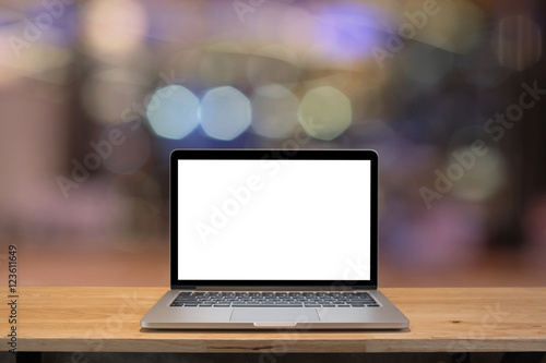 Laptop with blank screen on table with blur bokeh background