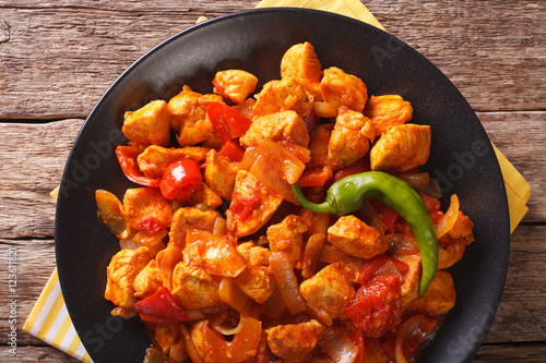 Indian curry Chicken Jalfrezi with spices, tomato sauce and capsicums. horizontal top view
