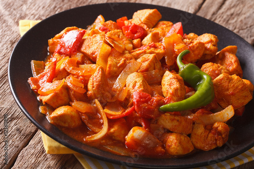Spicy chicken jalfrezi with pepper and onion close-up. horizontal
 photo