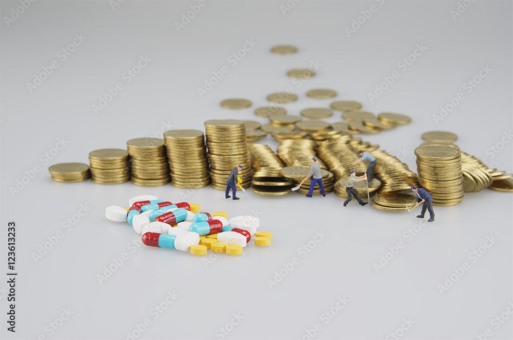 Stack of gold coin and miniature people Stack of gold coin and miniature people