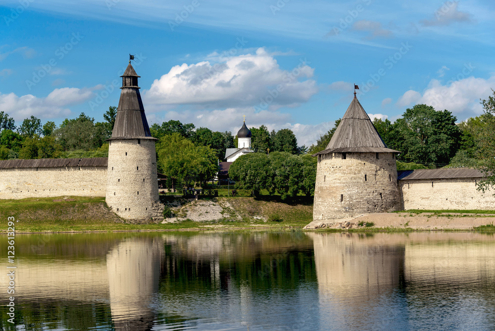 View of the Pskov Kremlin from Velikaya River in the summer in a sunny weather View of the Pskov Kremlin from Velikaya River in the summer in a sunny weather