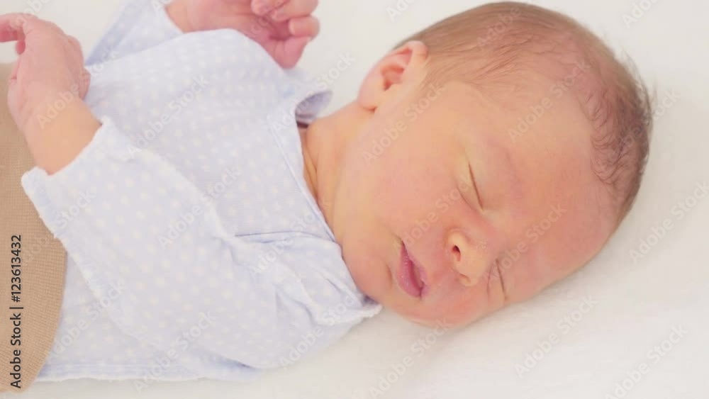 Sleeping newborn baby in blanket. Close up.
Sleeping newborn baby in blanket. Close up.