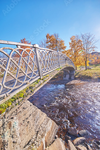 across the river bridge in the autumn park © enskanto