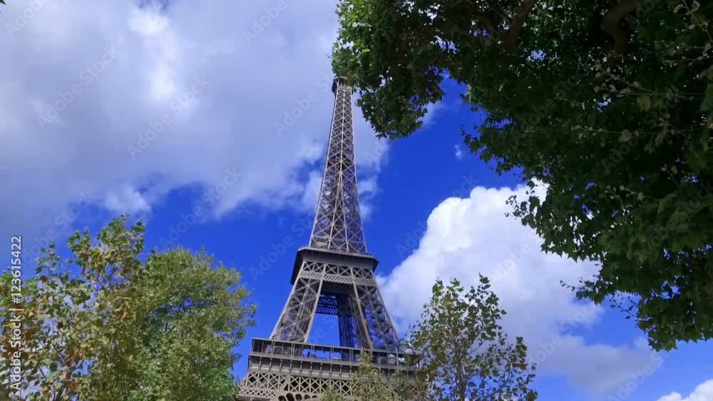 View of the Eiffel tower between trees. Slow motion. View of the Eiffel tower between trees. Slow motion.