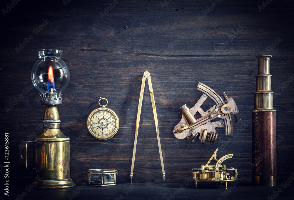 Compass, nautical lamp, sextant, telescope, old coins and a sundial on the  captain's Desk. Stock Photo | Adobe Stock