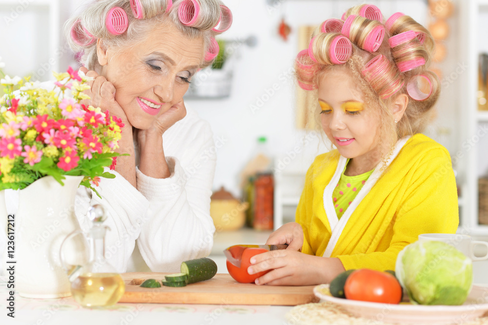 Senior woman and granddaughter at kitchen Senior woman and granddaughter at kitchen