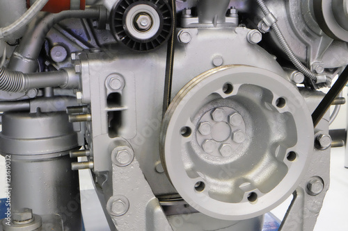 part of a modern engine from the truck. flywheel in the foreground.