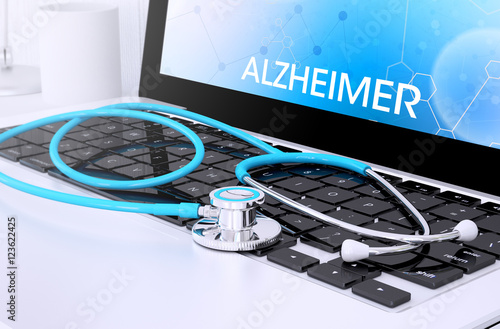 stethoscope on laptop keyboard with screen showing alzheimer photo