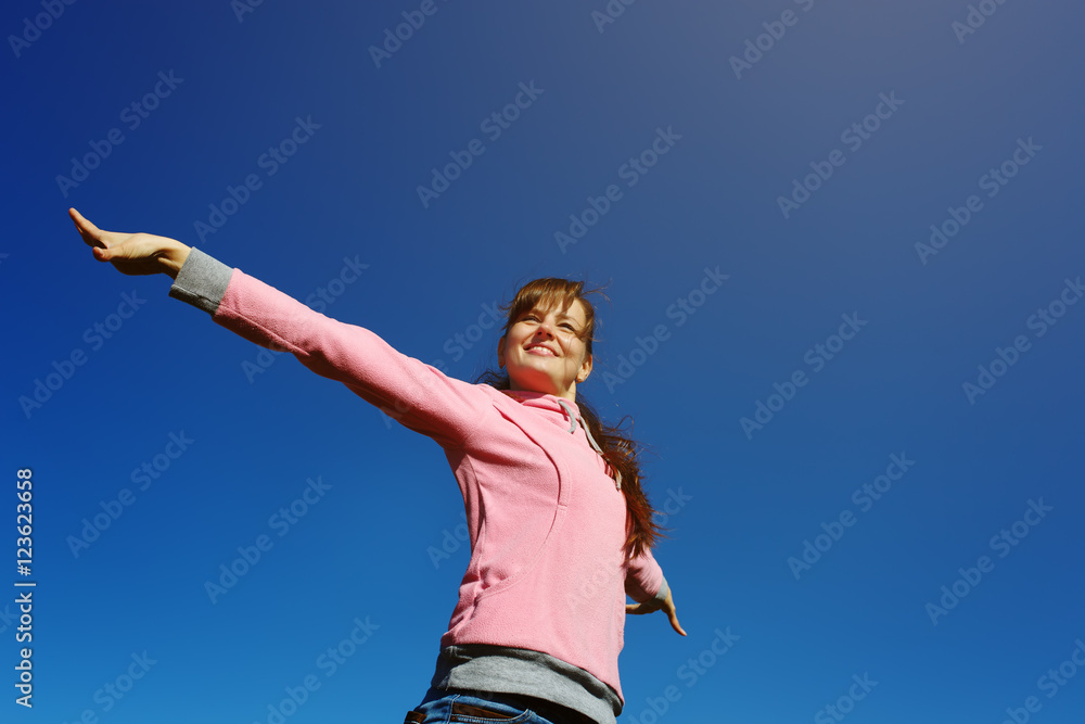 Beautiful young woman against the blue sky. Beautiful young woman against the blue sky.
