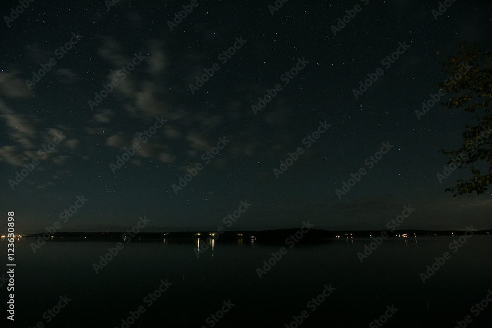 long exposure stars trees lake and sky long exposure stars trees lake and sky