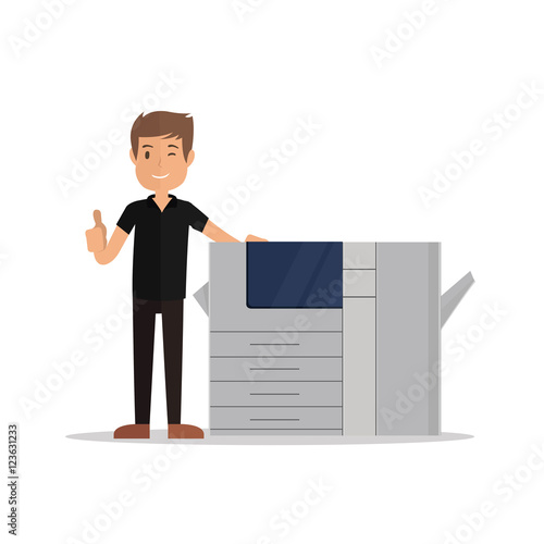 young man standing near printer and pointing thumbs up