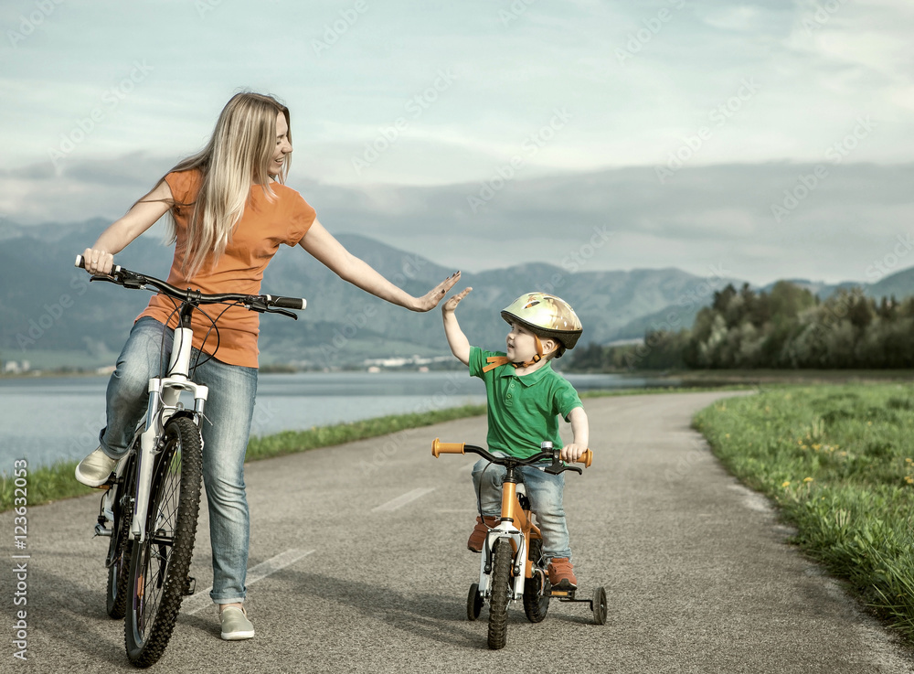 Happiness Mother and son on the bicycles funning outdoor Happiness Mother and son on the bicycles funning outdoor