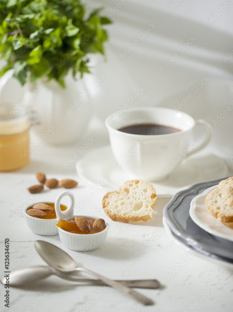 Cup of tea with biscuits and apricot jam