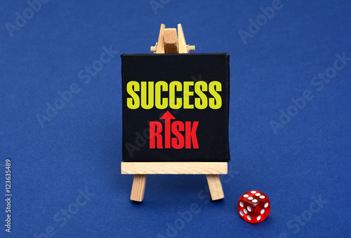 Risk Success Concept with dice and chalkboard