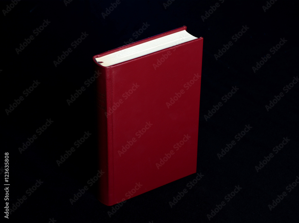 Red Book with Cover - Blue Spot light on black background Red Book with Cover - Blue Spot light on black background