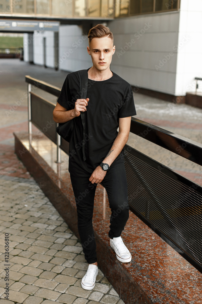 Handsome hipster man stylish black t-shirt, pants and white shoes Stock Photo | Adobe Stock