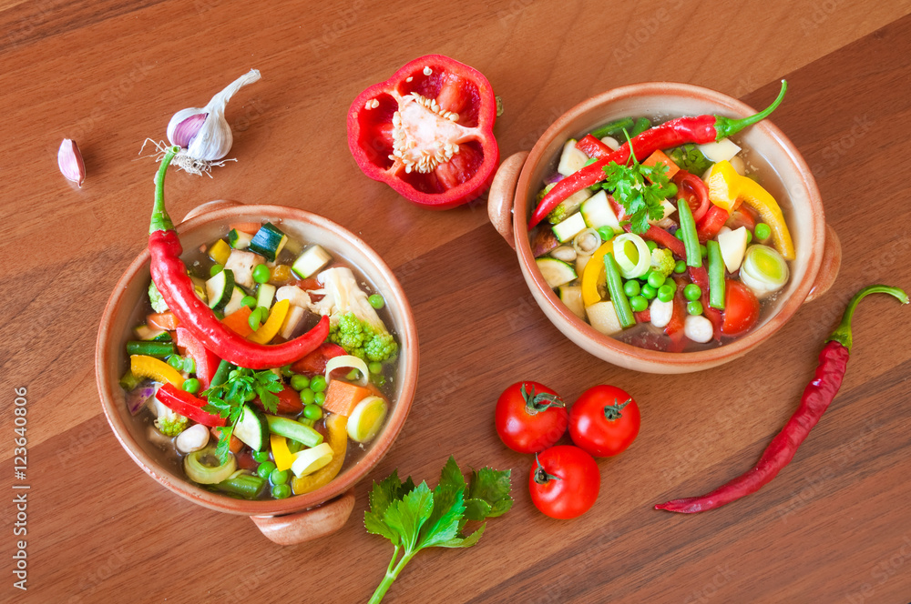 Hot vegetable soup on wooden table Hot vegetable soup on wooden table