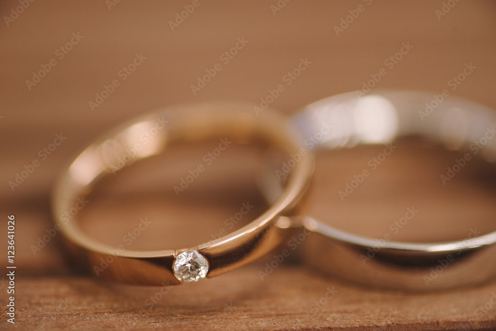 Wedding rings on wooden background. Shallow focus. Wedding rings on wooden background. Shallow focus.