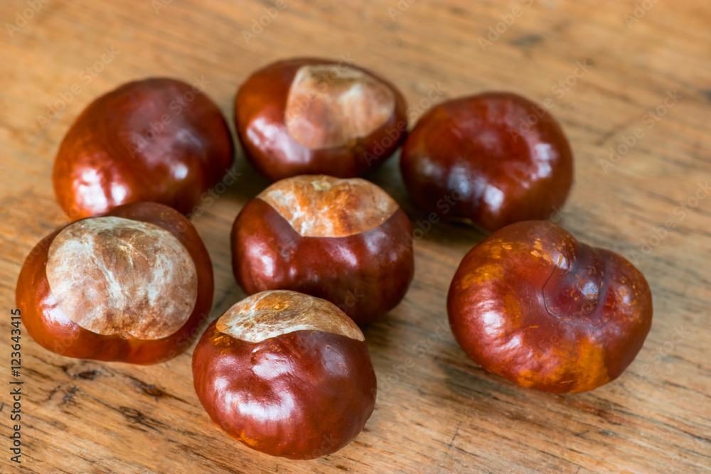 Fresh chestnuts on a rustic wooden background Fresh chestnuts on a rustic wooden background