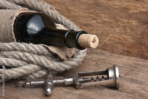 Old corkscrew and bottle of wine