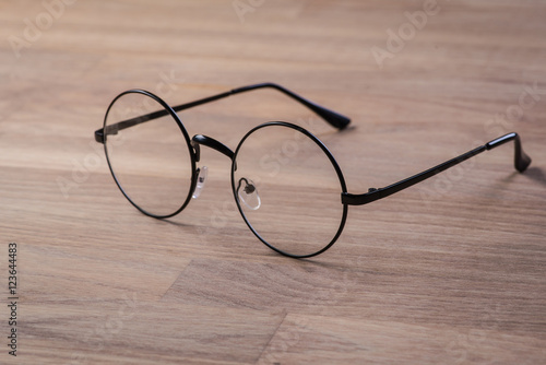 Vintage reading glasses on the wooden surface