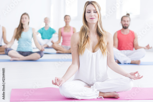 People sitting concentrated on yoga class